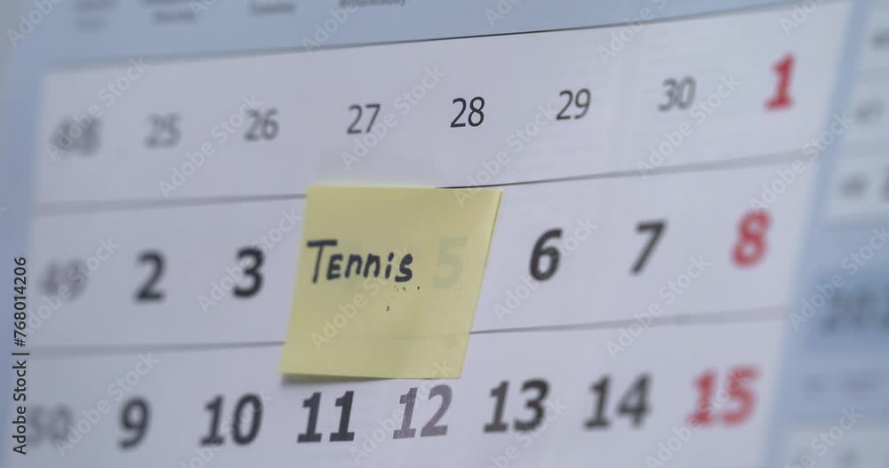 Woman is looking at a colorful schedule. Remind about tennis training Woman is looking at a colorful schedule. Remind about tennis training