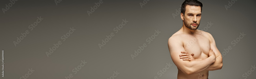 horizontal banner of handsome man with bare chest posing with crossed arms on grey background horizontal banner of handsome man with bare chest posing with crossed arms on grey background