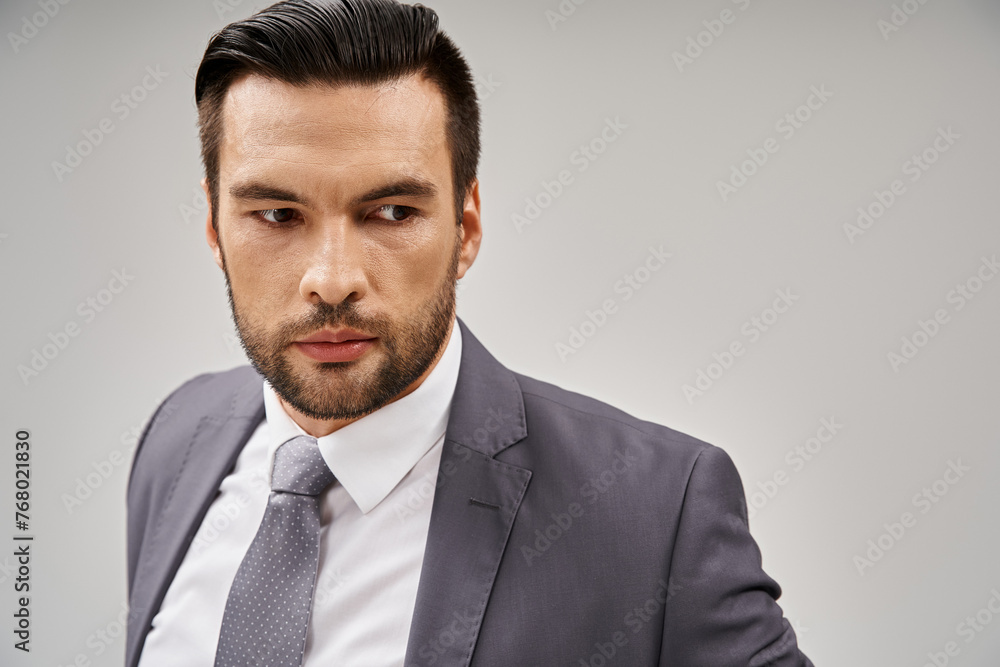portrait of handsome businessman in stylish attire posing on grey background, tailored suit portrait of handsome businessman in stylish attire posing on grey background, tailored suit