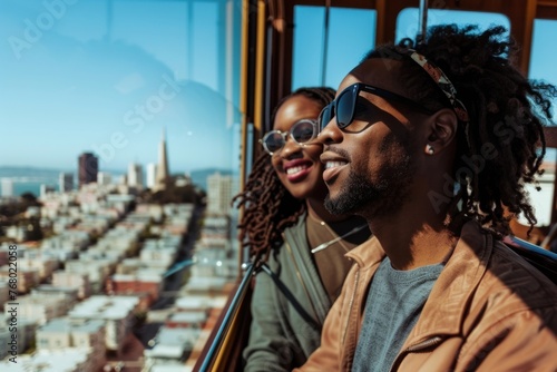 Happy African-American couple enjoying a romantic sightseeing excursion on a San Francisco cable car with breathtaking cityscape views