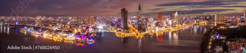 Aerial panoramic cityscape view of HoChiMinh city and the River Saigon  Vietnam with blue sky at sunset. View from Thu Thiem peninsula