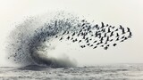 A dramatic burst of birds takes flight from a churning ocean wave, creating a dynamic interplay between sea and wildlife.