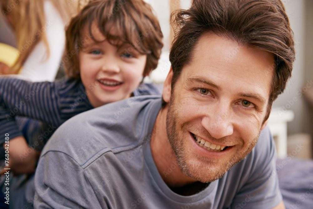 Happy, portrait and father with child on bed bonding, relaxing and having fun together at modern home. Laughing, smile and dad playing with boy kid in bedroom on weekend at family house in Canada. Happy, portrait and father with child on bed bonding, relaxing and having fun together at modern home. Laughing, smile and dad playing with boy kid in bedroom on weekend at family house in Canada.