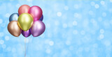 Bunch of shiny colorful balloons on blurred blue background. Empty space for text. 3d rendering