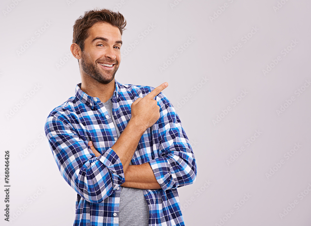 Portrait, pointing and casual man in studio with smile, deal announcement and happy face. Showing, advice and creative person at presentation at offer, notification and white background mockup Portrait, pointing and casual man in studio with smile, deal announcement and happy face. Showing, advice and creative person at presentation at offer, notification and white background mockup