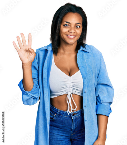 Beautiful hispanic woman wearing casual denim jacket showing and pointing up with fingers number four while smiling confident and happy.