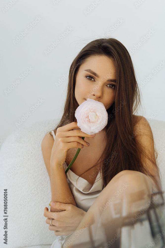Beautiful young woman with pink flower isolated on white background Beautiful young woman with pink flower isolated on white background