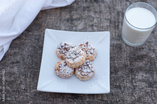 Freshly baked cookies on plate with glass of milk.