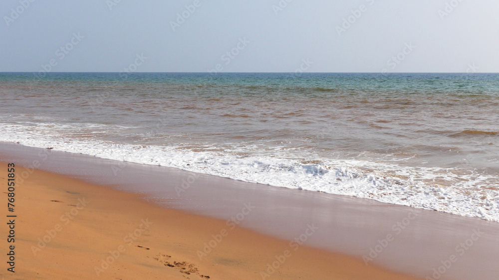 The foam of turbulent wave on the beach at Veli, Thiruvananthapuram, Kerala, India