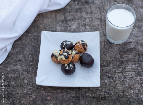 Freshly baked cookies on plate with glass of milk.