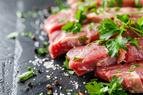 A detailed view of raw meat placed on a wooden cutting board, with a garnish of fresh parsley