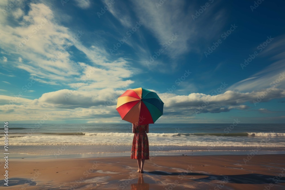 Woman with colorful umbrella on a beach