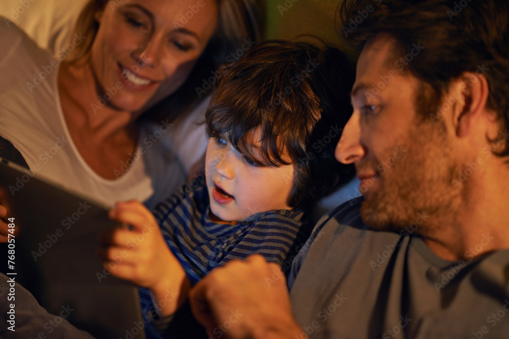 Bed, parents or kid with tablet for streaming, playing games or watching videos on movie website in home. Social media, child or happy mom with dad or technology to download on ebook online at night Bed, parents or kid with tablet for streaming, playing games or watching videos on movie website in home. Social media, child or happy mom with dad or technology to download on ebook online at night