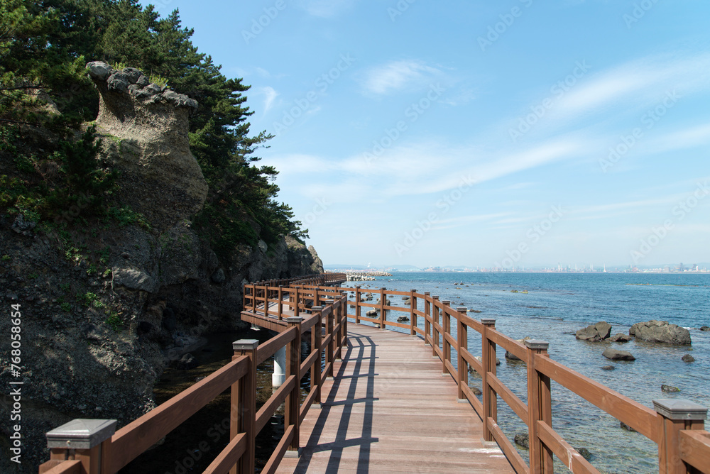 View of the seaside with the wooden footbridge View of the seaside with the wooden footbridge