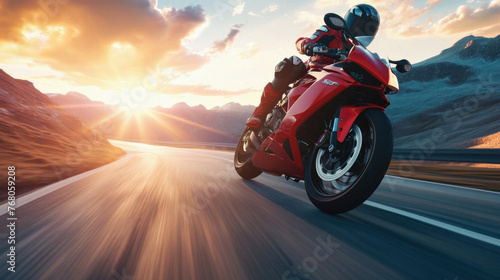 Motorcycle riding on the road at sunset .