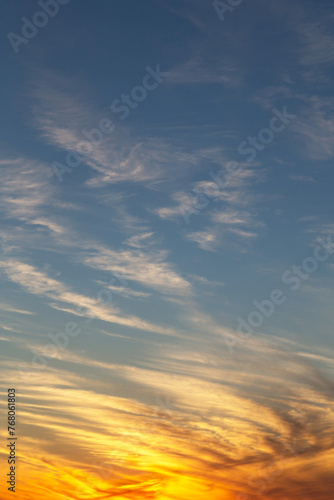 Epic Dramatic sunrise, sunset blue sky with cirrus clouds and yellow orsnge sunlight abstract background texture
