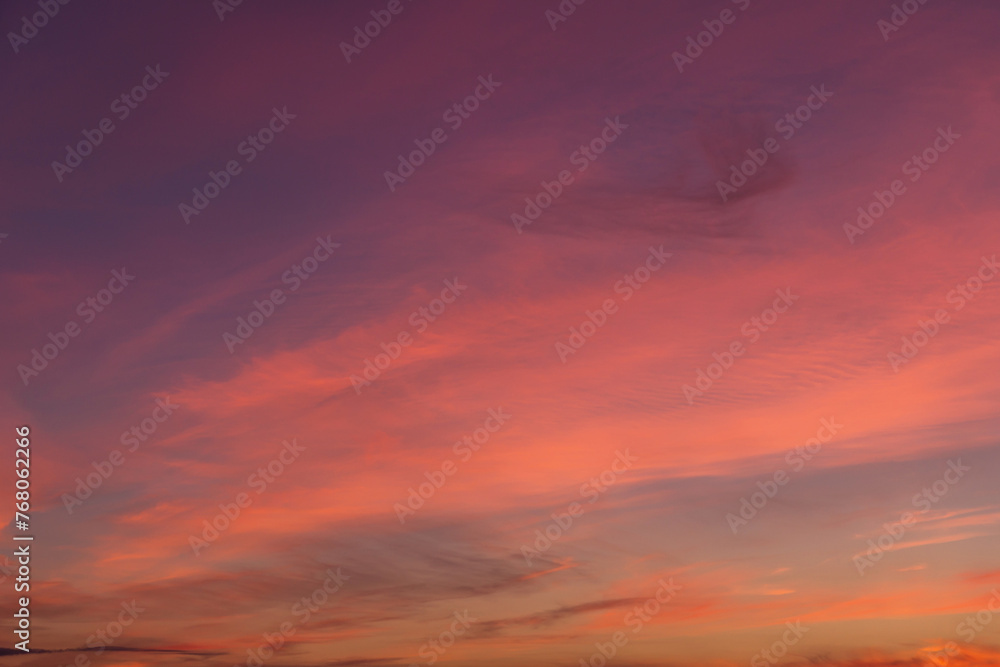 Epic Dramatic soft sunrise, sunset pink orange sky with cirrus clouds in sunlight abstract background texture