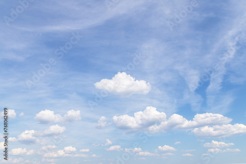 Beautiful epic soft gentle blue sky with white cirrus and fluffy clouds background texture