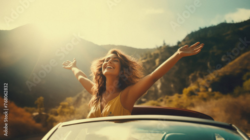 Happy young woman in the cabriolet car on a sunny day