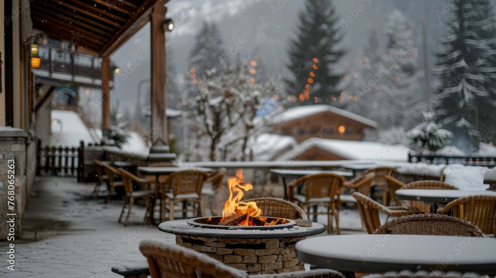 Outdoor fireplace Fire Pit in a snowy setting on a restaurant terrace in the mountains