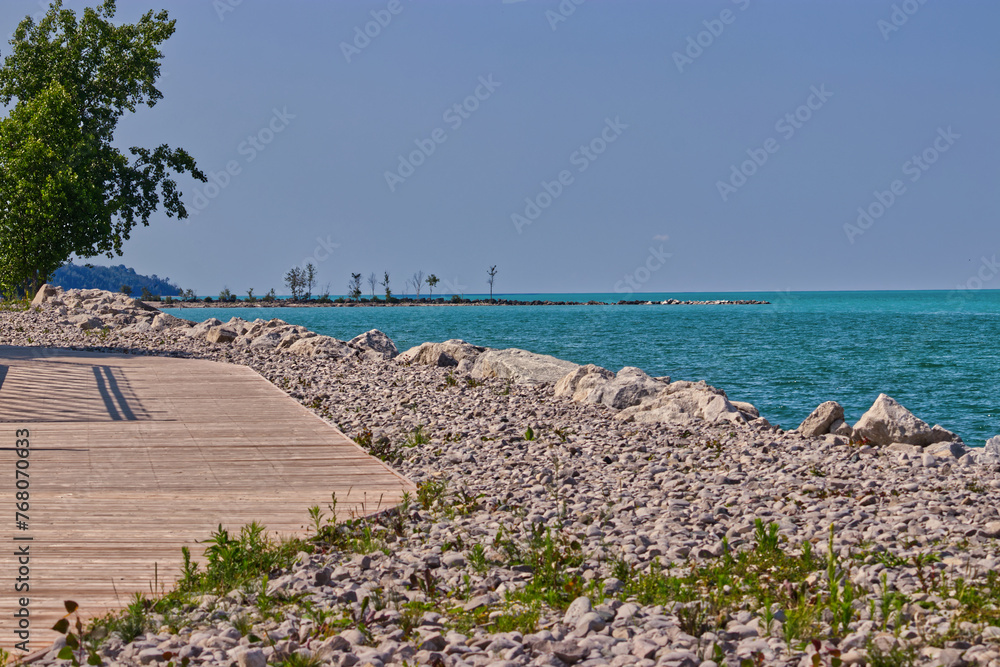 Rocks of all sizes and a wooden boardwalk on the beach - Goderich, ON, Canada