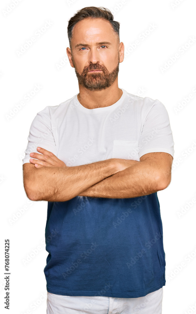 Handsome middle age man wearing casual tie dye tshirt skeptic and nervous, disapproving expression on face with crossed arms. negative person. Handsome middle age man wearing casual tie dye tshirt skeptic and nervous, disapproving expression on face with crossed arms. negative person.