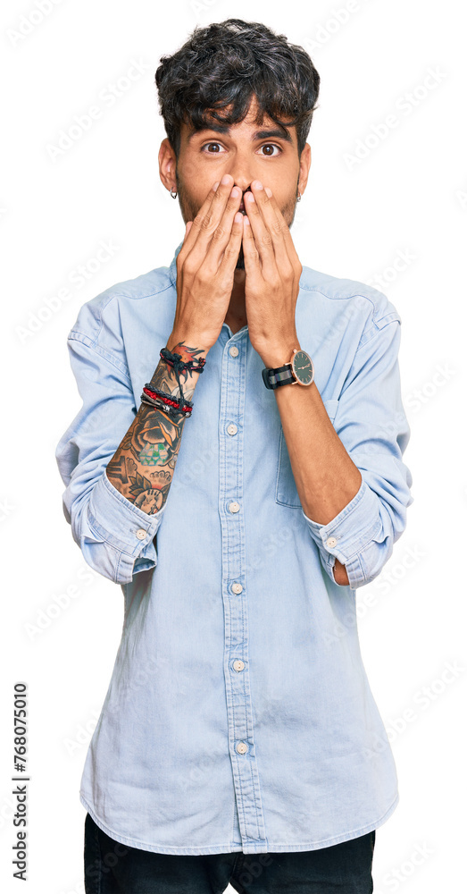 Young hispanic man wearing casual clothes laughing and embarrassed giggle covering mouth with hands, gossip and scandal concept Young hispanic man wearing casual clothes laughing and embarrassed giggle covering mouth with hands, gossip and scandal concept