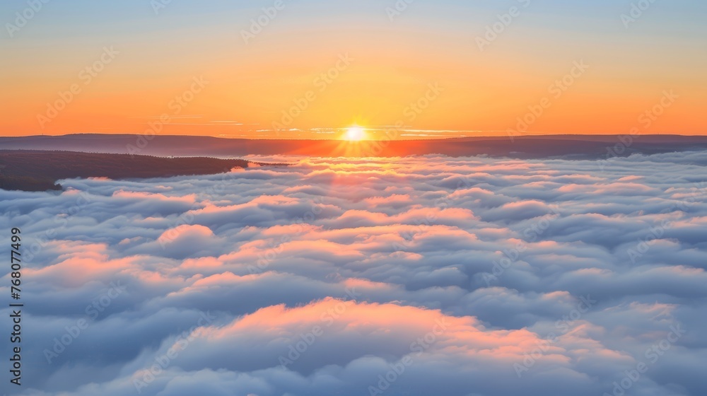 Majestic sunrise over mountains with clouds and fog in orange morning sky, a stunning landscape view