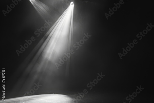A dark room with a spotlight shining on it. The light is bright and focused, creating a dramatic effect