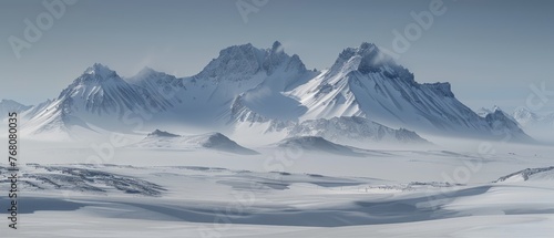  A group of snow-covered mountains on a winter day with scattered clouds in the sky