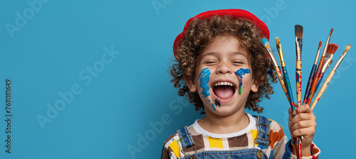 Generated cute kid holding paint brush on blue color background, generative ai