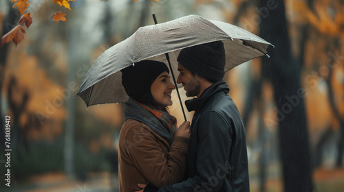 Romantic couple in love under umbrella in rainy day. Man and woman enjoy relationship and happiness together in winter autumn rain. Romance and people smiling end hugging at the park in leisure moment