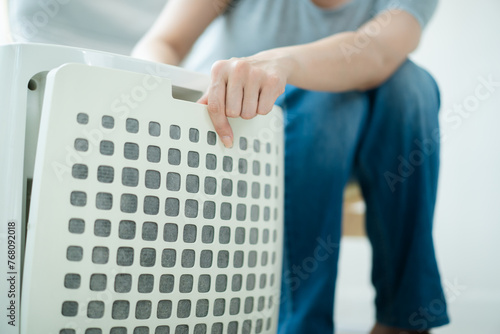 Woman replaces a dirty and dusty air purifier filter in living room. 