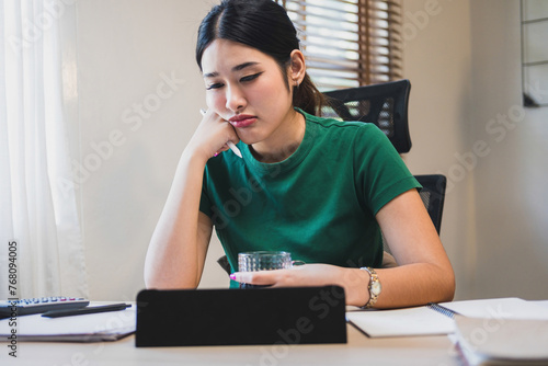 Businesswoman is thinking and is stressed about work.