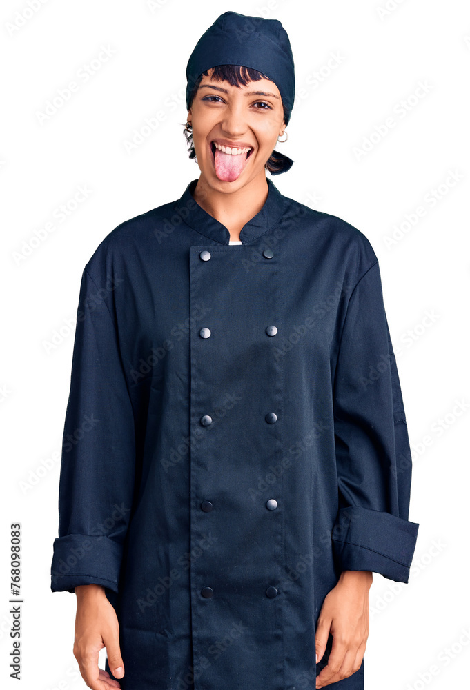 Young brunette woman with short hair wearing professional cook uniform sticking tongue out happy with funny expression. emotion concept. Young brunette woman with short hair wearing professional cook uniform sticking tongue out happy with funny expression. emotion concept.