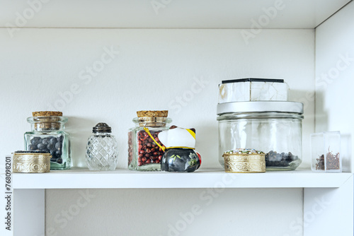 Decorative glass objects on a white square shelf