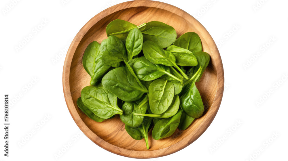 wooden round plate with fresh spinach leaves, isolated on a white background. top view wooden round plate with fresh spinach leaves, isolated on a white background. top view