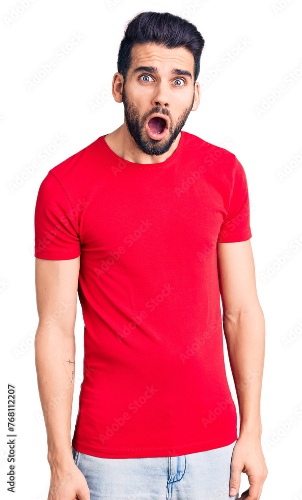 Young handsome man with beard wearing casual t-shirt afraid and shocked with surprise expression, fear and excited face. Young handsome man with beard wearing casual t-shirt afraid and shocked with surprise expression, fear and excited face.
