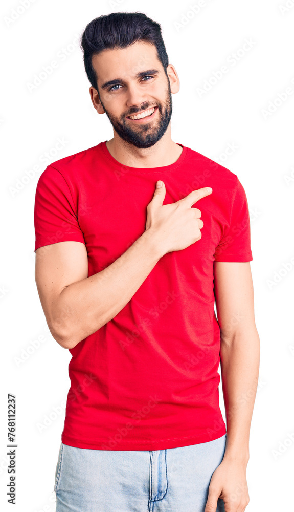 Young handsome man with beard wearing casual t-shirt cheerful with a smile of face pointing with hand and finger up to the side with happy and natural expression on face Young handsome man with beard wearing casual t-shirt cheerful with a smile of face pointing with hand and finger up to the side with happy and natural expression on face