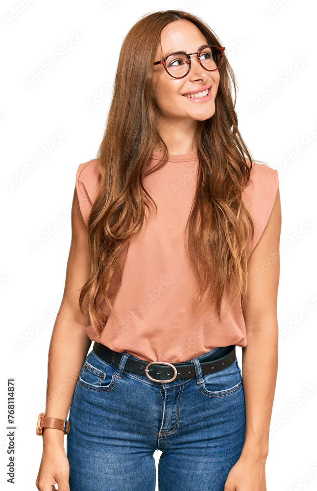 Young hispanic woman wearing casual clothes and glasses looking away to side with smile on face, natural expression. laughing confident. - obrazy, fototapety, plakaty 