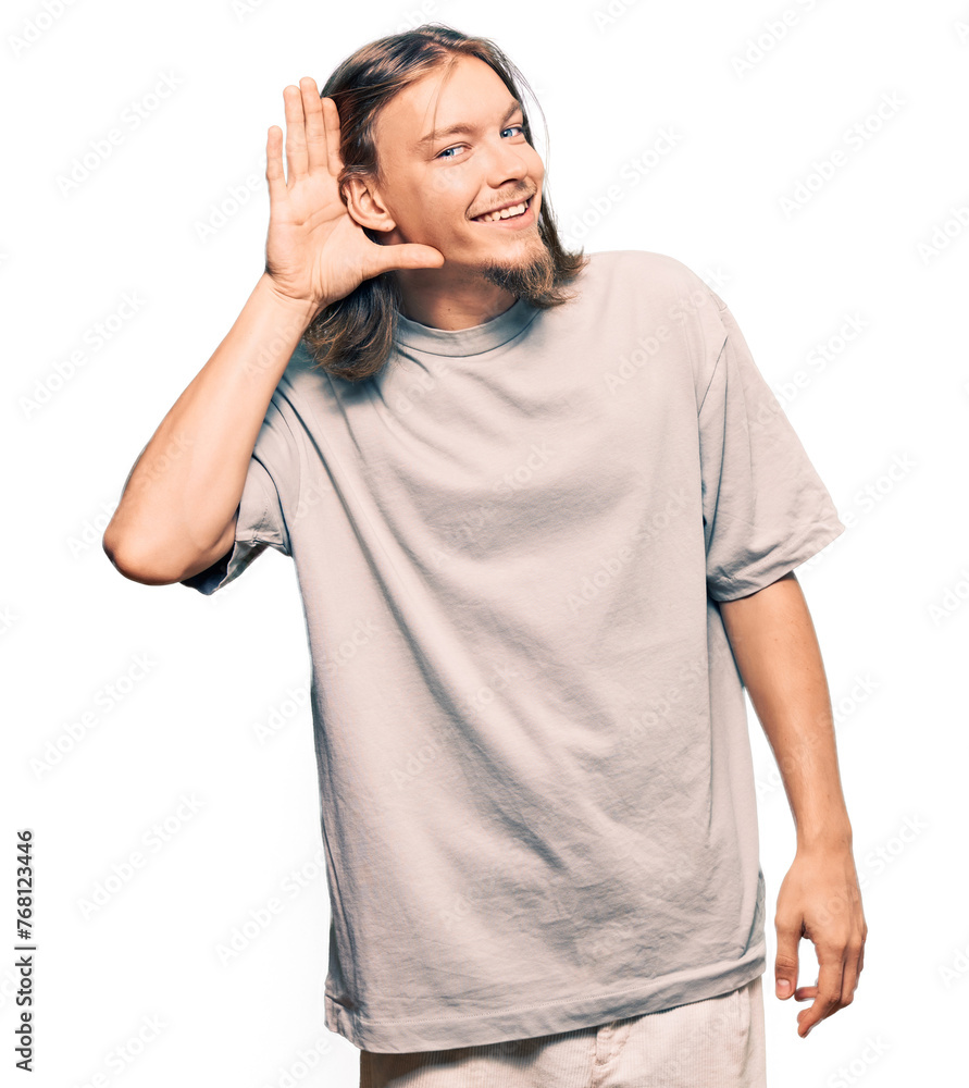 Handsome caucasian man with long hair wearing casual clothes smiling with hand over ear listening an hearing to rumor or gossip. deafness concept. Handsome caucasian man with long hair wearing casual clothes smiling with hand over ear listening an hearing to rumor or gossip. deafness concept.