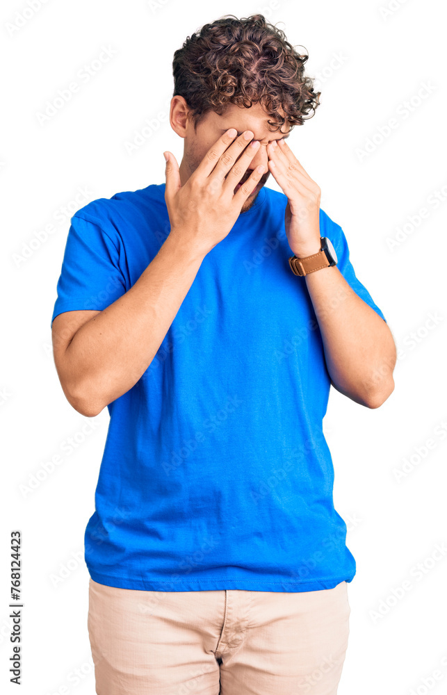 Young handsome man with curly hair wearing casual clothes rubbing eyes for fatigue and headache, sleepy and tired expression. vision problem Young handsome man with curly hair wearing casual clothes rubbing eyes for fatigue and headache, sleepy and tired expression. vision problem