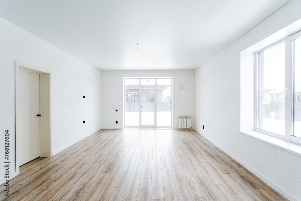 Empty living room with hardwood floors and white walls Empty living room with hardwood floors and white walls