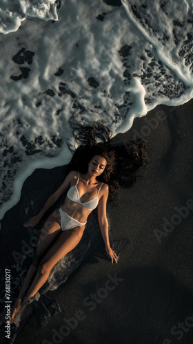 Aerial view of woman lying on beach