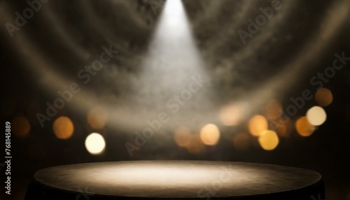Defocused view on empty studio background lit from top by round spotlight. Visible light cone
