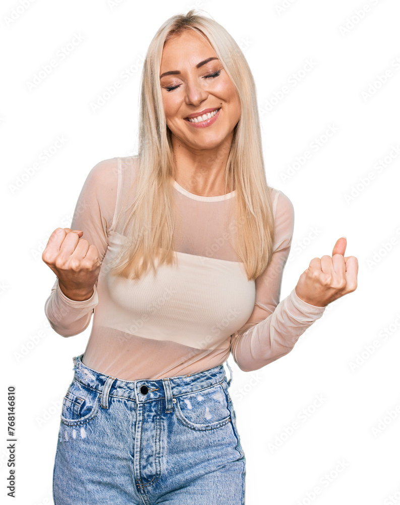Φωτογραφία Young blonde woman wearing casual clothes very happy and excited doing winner gesture with arms raised, smiling and screaming for success