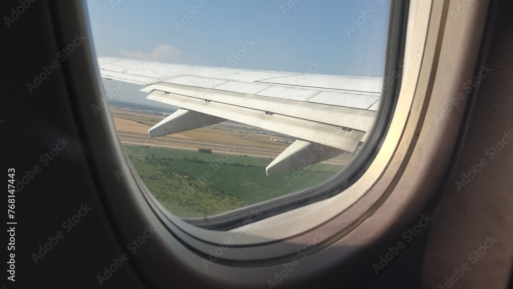 Airplane window view of take off departure from airport runway