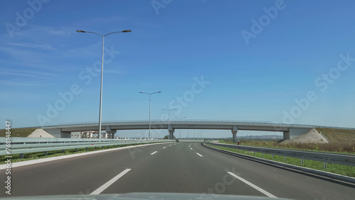 Front view driving on highway under a passage