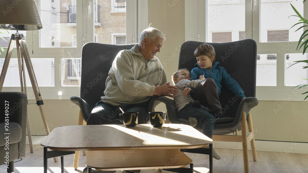Little brothers spend time with their grandfather at home Little brothers spend time with their grandfather at home
