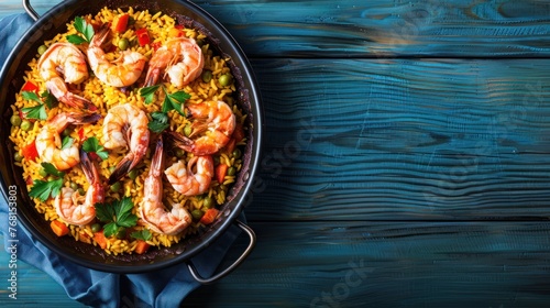 Top view tasty paella with shrimp food menu on plate isolated a blue wooden background. AI generated